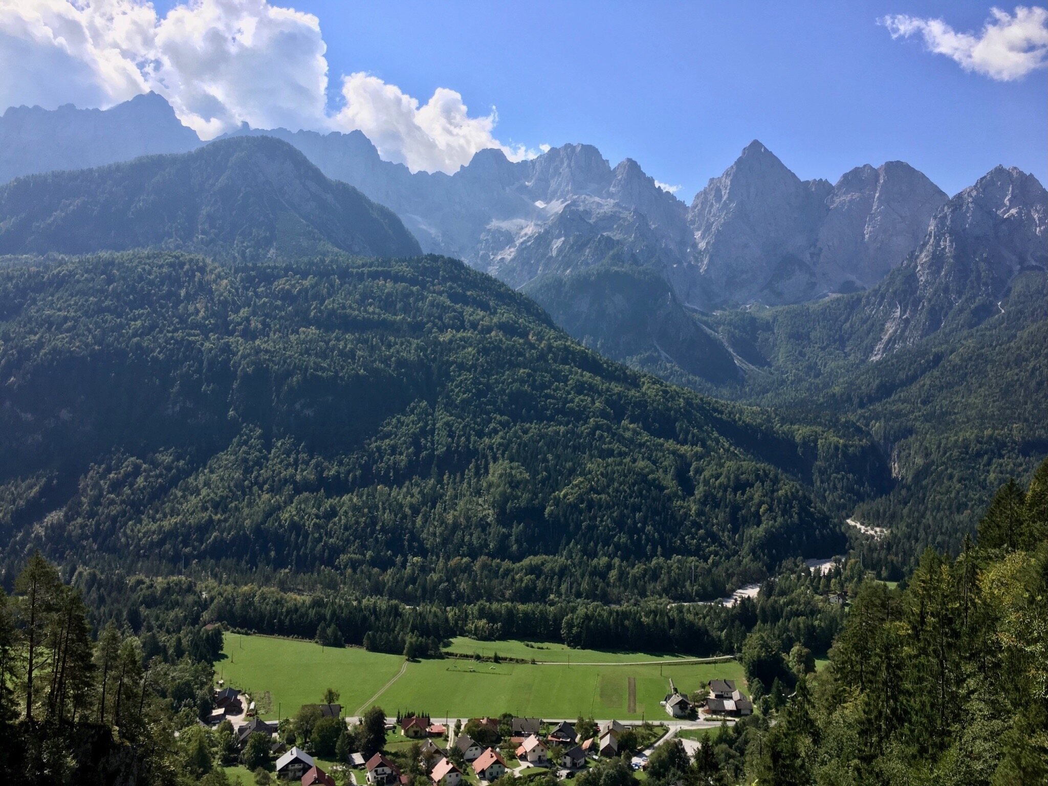 View across a green valley towards the Julian Alps